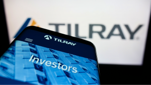 Mobile phone with webpage of Canadian cannabis company Tilray (TLRY) Inc. on screen in front of business logo. Focus on top-left of phone display. Unmodified photo.
