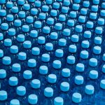 Lots of water bottles. Bottles with blue caps.