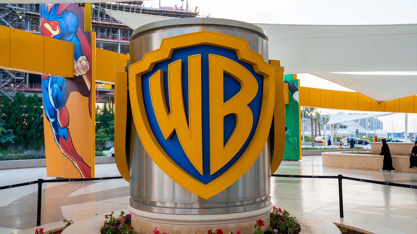 A close-up of the blue and yellow Warner Bros (WBD) sign.