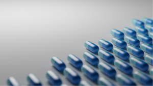 Light blue pills on white background. Pharmaceutical industry, medical treatment, presciption drugs concept. Digital 3D render., biotech stocks, big pharma