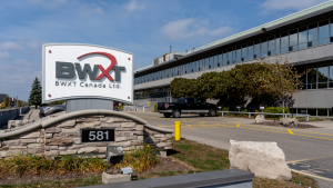 The logo for BWX Technologies (BWXT) is shown on a sign outside of an office building.