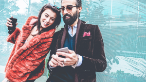 Trendy influencers people using smartphone social media app - Young fashion couple watching story video on mobile phone - Technology trends, marketing and new digital job concept - Focus on man face, Citi Trends (CTRN), a micro-cap stock