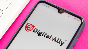 Digital Ally logo on a phone screen over a hot pink background. DGLY stock.