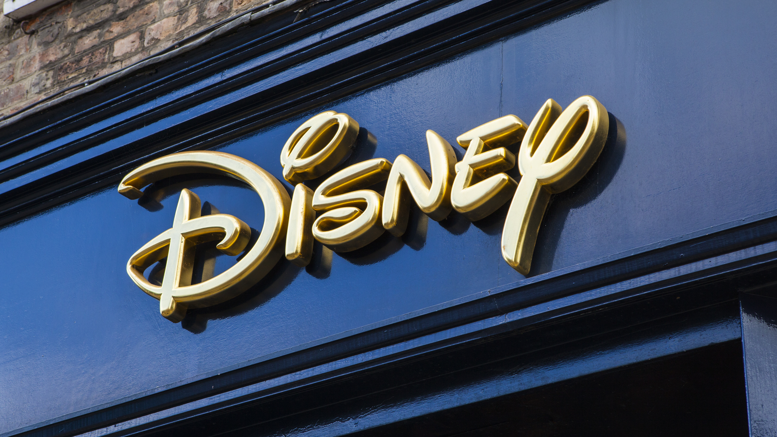 Disney logo on a store front. DIS stock representing Bob Iger news.