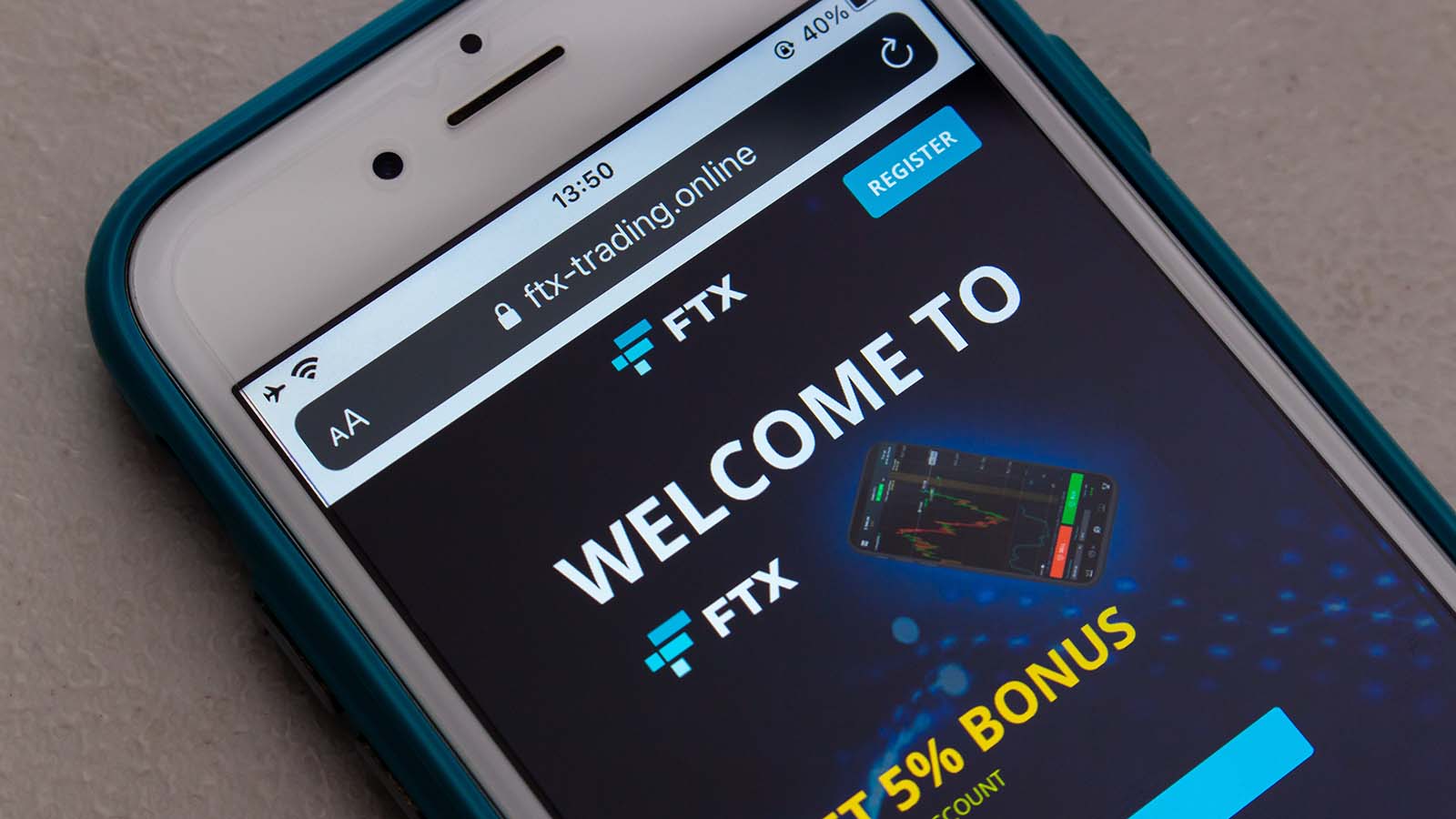 The website for the FTX exchange is displayed on an iPhone screen.