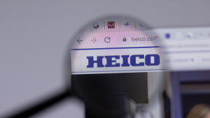 The website for Heico is shown with a magnifying glass enlarging the company's logo.