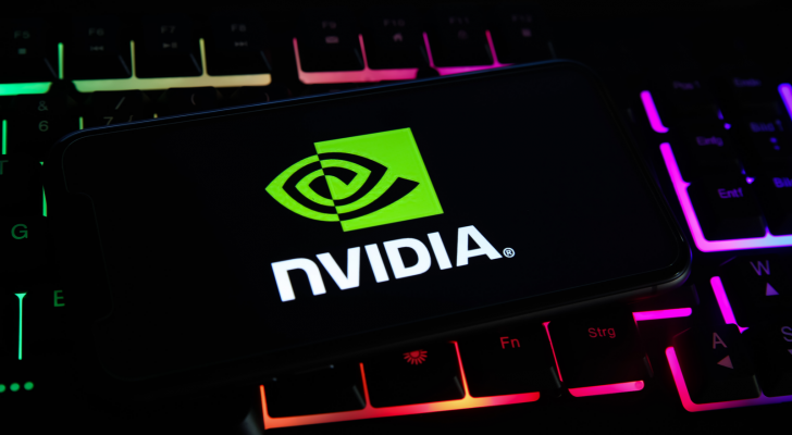 Closeup of mobile phone screen with logo lettering of nvidia corporation on computer keyboard. NVDA stock.