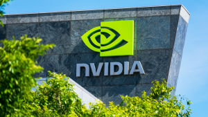 Nvidia (NVDA) logo and sign at headquarters.  Blurred foreground with green trees