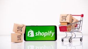 Shopify (SHOP) on the phone display. Growth stocks that will outperform the nasdaq