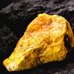 Uranium on top of black rock background.
