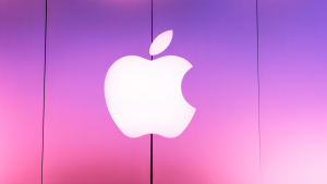 Apple logo on a pink and purple background.