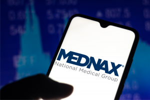 Mednax logo on a phone screen. MD stock.