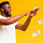 A man enthusiastically throws several dollar bills out. millennial stocks