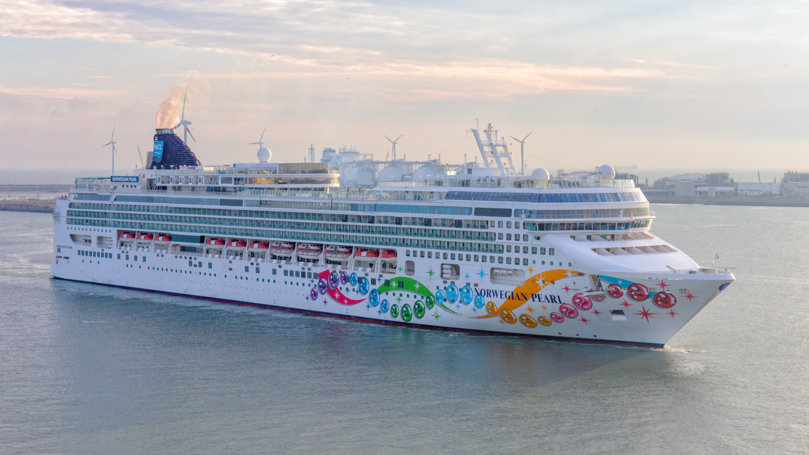Norwegian Cruise Line ship arriving at a port. NCLH stock.