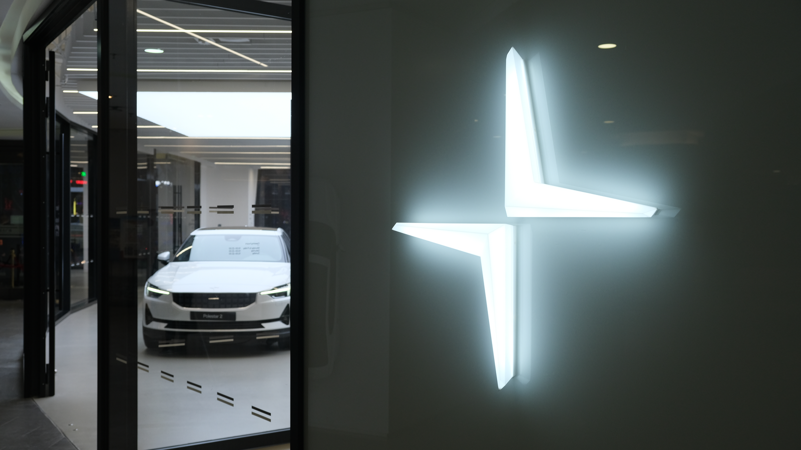 Close up Polestar logo with electric car in store. Polestar (PSNY Stock) is a Swedish automotive brand owned by Volvo Cars and Geely