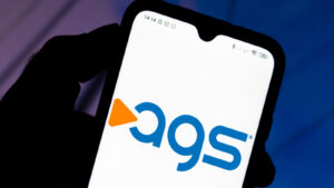 PlayAGS logo on a smartphone. AGS stock.