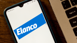 Elanco Animal Health logo on a smart phone screen next to a keyboard. ELAN stock.