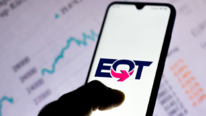 This photo illustration features the EQT Corporation logo displayed on a smartphone.