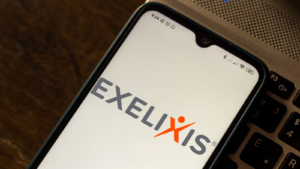 The logo for Exelixis is displayed on a phone.