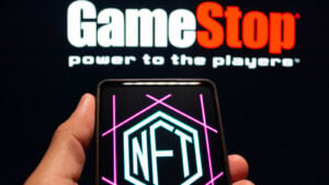 The GameStop (GME) logo above the NFT logo on a smartphone.