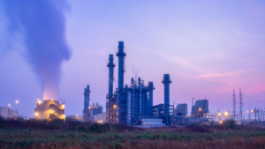 Natural Gas Combined Cycle Power Plant with sunset and light orange. Best natural gas stocks to buy.