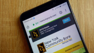 New York Community Bancorp logo on a smartphone screen. NYCB stock