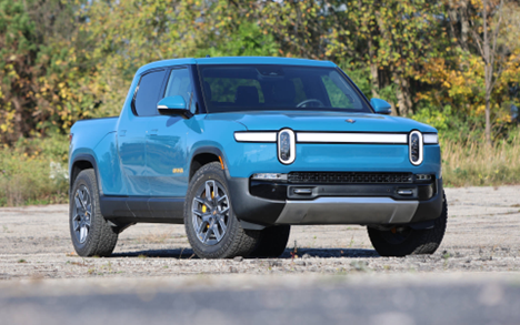 An image of a blue electric pick-up truck; Rivian's R1T
