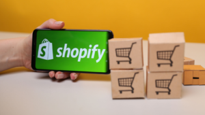 Shopify on the phone screen.