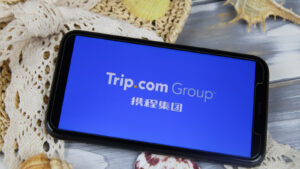 Trip.com Group logo on a smartphone. TCOM stock.