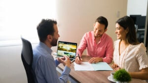 Couple signing timeshare agreement with realtor.