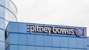 The office logo for Pitney Bowes on a glass building.