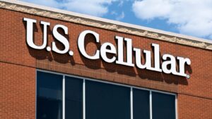 The logo for U.S. Cellular displayed on a brick office building.
