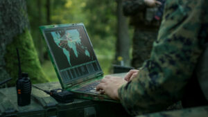 An Army soldier using a laptop representing BBAI Stock.