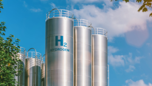 An image of hydrogen fuel silos standing against a blue sky