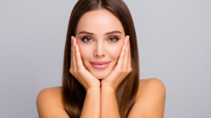 Close-up portrait of a confident woman touching her face, symbolizing RVNC stock