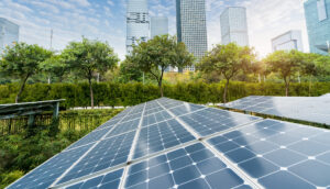 An image of solar panels with cityscape of a modern city