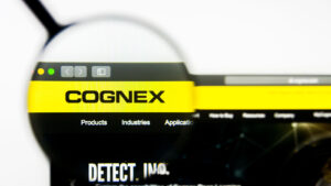 CGNX stock website homepage. Cognex Corporation logo visible on display screen.