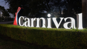 Carnival (CCL) logo sign in the night at their headquarters in Miami, Florida, USA. Carnival Cruise Line is an international cruise line.