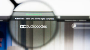 AUDC stock: A magnifying glass over the logo on the Audiocodes website 