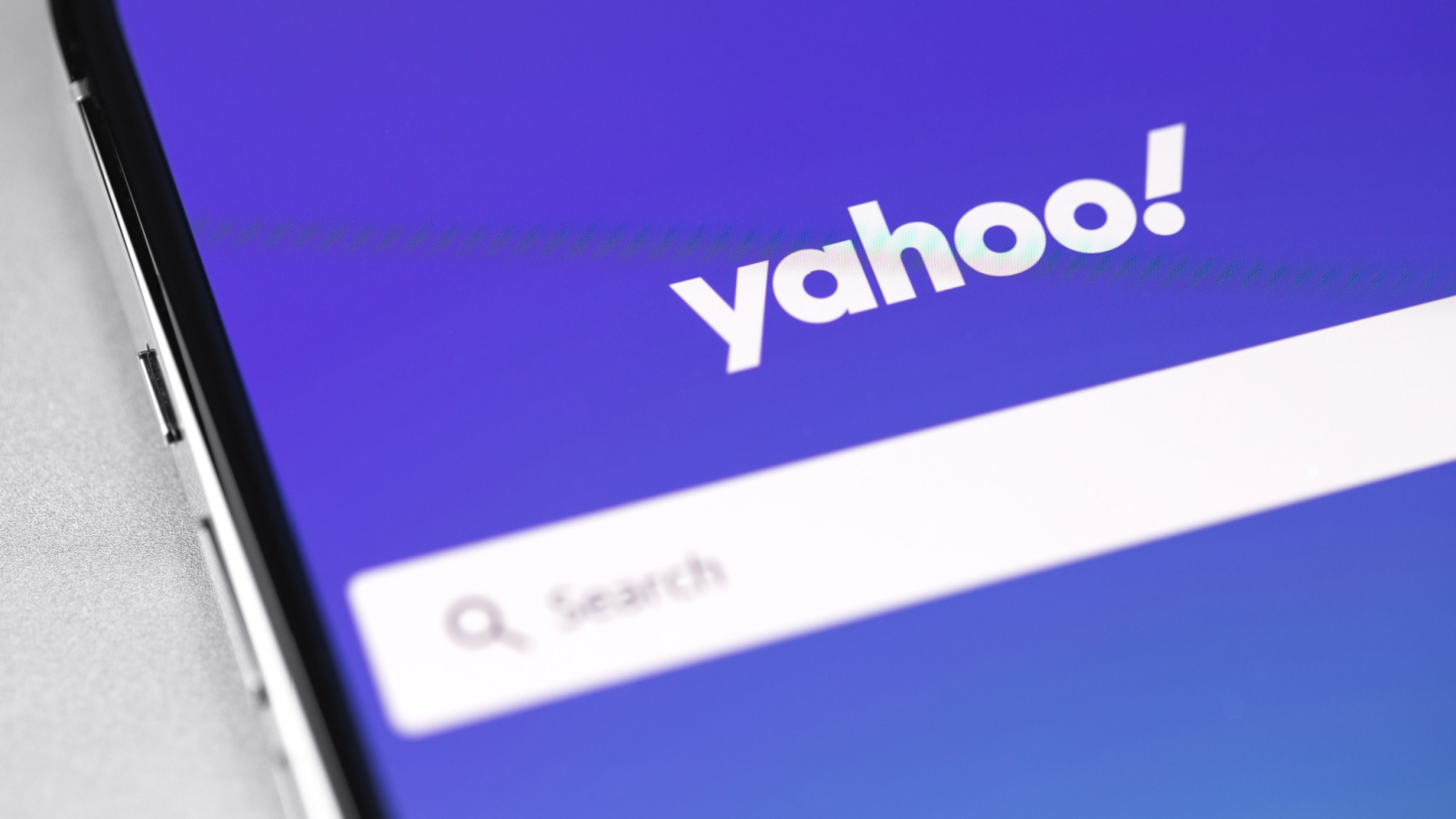 Yahoo! logo displayed on smartphone with purple-blue background