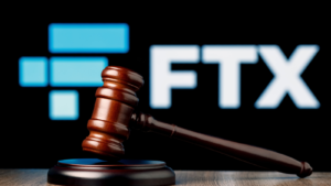 A gavel rests in front of the logo for FTX.