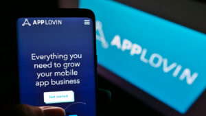 AppLovin (APP) logo and page displayed on phone and computer screen