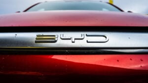 Close-up of BYD (BYDDY) logo on red car, symbolizing BYDDY stock