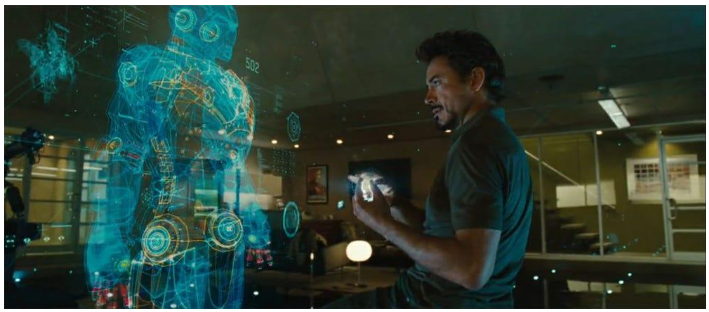 A still image from Marvel's Iron Man; Robert Downey Jr. interacting with a holographic AI interface