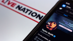 Twitter account of popular US singer-songwriter Taylor Swift in Twitter website seen in iPhone on Live Nation (LYV) logo background. Selective focus