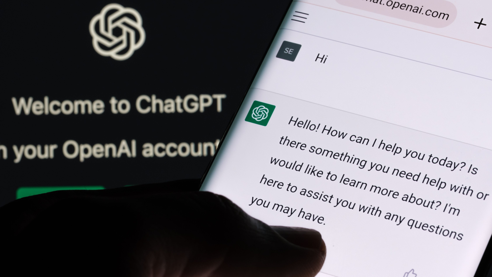 ChatGPT chat bot screen seen on smartphone and laptop display with Chat GPT login screen on the background. A new AI chatbot by OpenAI.
