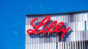 Eli Lilly (LLY) sign on company building with blue sky in the background