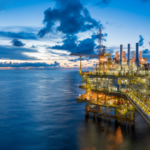 Panorama of Oil and Gas central processing platform in twilight, offshore hard work occupation twenty four working hours. Best oil stocks to buy