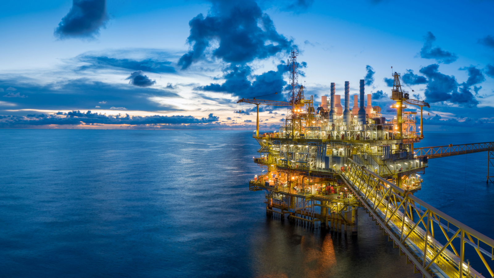 Panorama of Oil and Gas central processing platform in twilight, offshore hard work occupation twenty four working hours. Best oil stocks to buy. Oil 