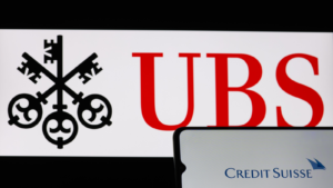 Smartphone with Credit Suisse Bank (CS) logo on background of UBS Bank symbol blurred, Switzerland, March 18, 2023
